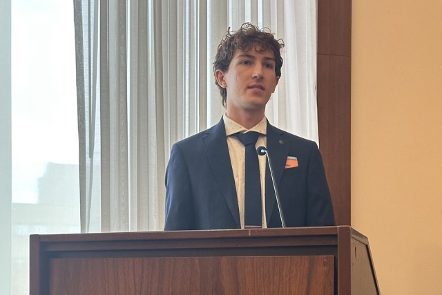 Male student speaking at podium