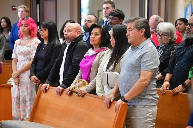 People standing in pews 