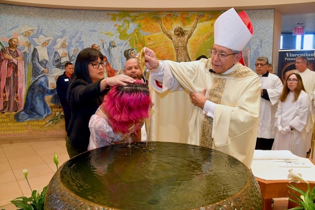woman being baptized by Bishop