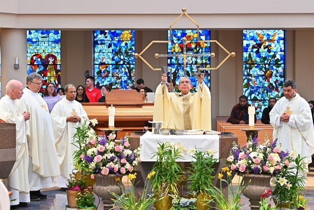 Snapshot of priest and altar servers on altar during Mass