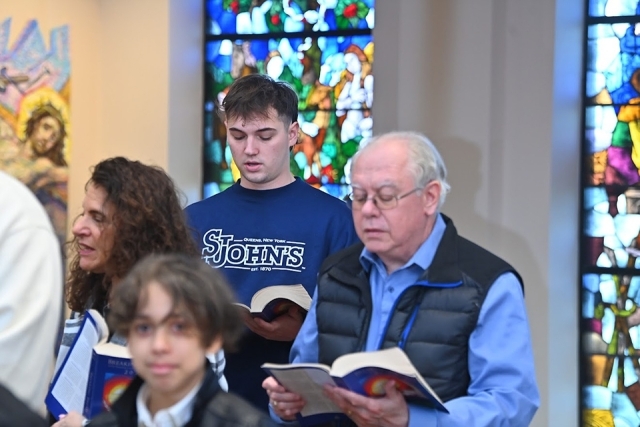 Inset of people in the pews singing during service
