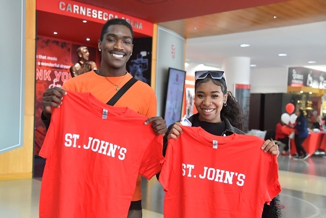 Two students hold St. John's tshirts