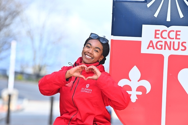 St. John's Student making heart symbol with her hands