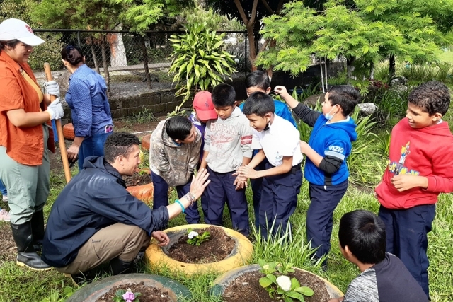 St. John's student on Plunge retreat interacting outside with kids