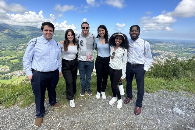 St. John's students on Plunge retreat pose for a photo at top of mountain