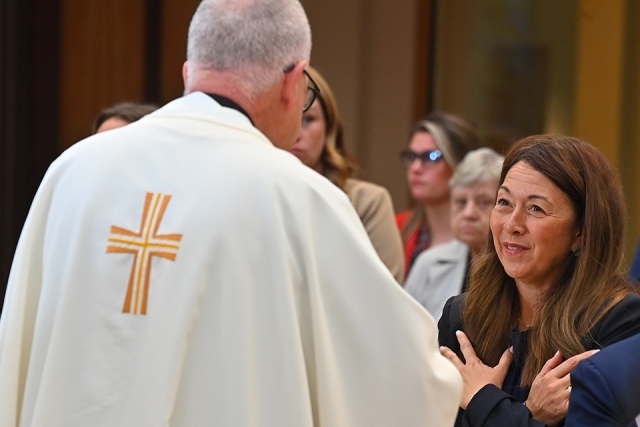 Woman receiving communion blessing at Mass
