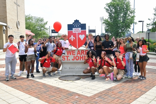 St. John's students infront of We Are St. John's sign