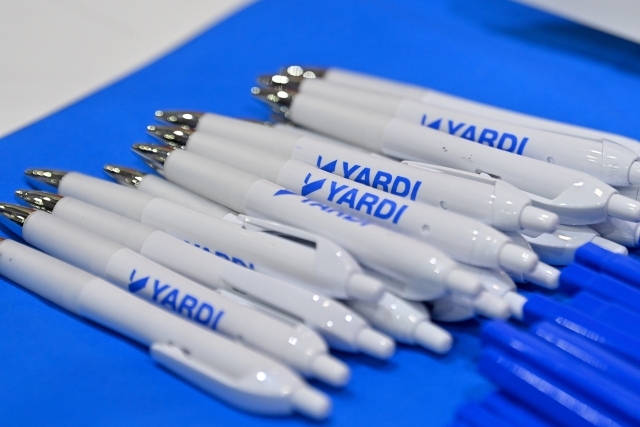 Yardi company pens on a blue table