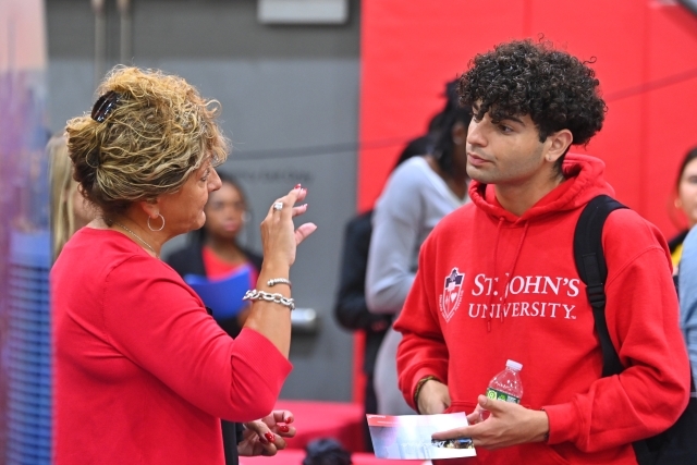 Student interacting with career expo rep