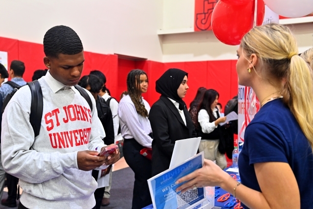 Student interacting with career expo rep