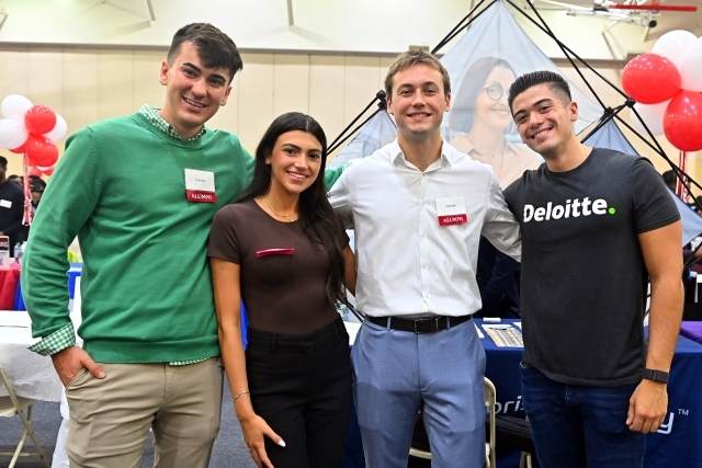 Career expo reps and attendees posing for a photo