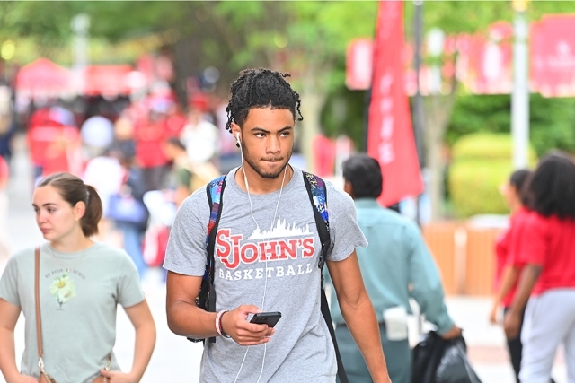 St. John's Men's Basketball player walking on campus