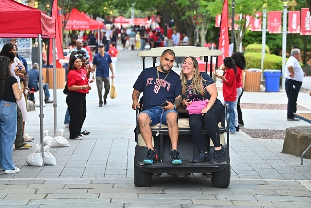 St. John's students riding on golf cart