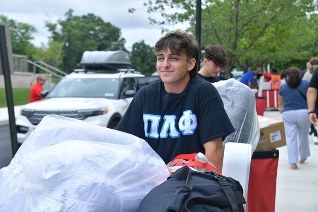 St. John's student rolling belongings in a cart