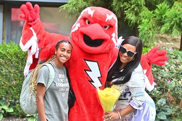 Johnny Thunderbird poses for a photo with two women