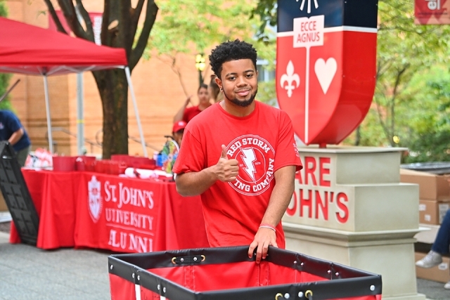 Red Storm Moving Company crew member gives a thumbs up