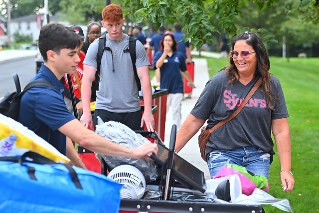 St. John's students and family members rolling carts