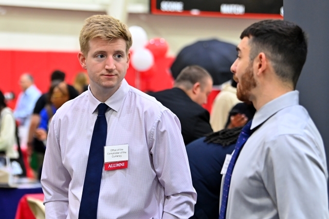 St. John's alum speaking with male