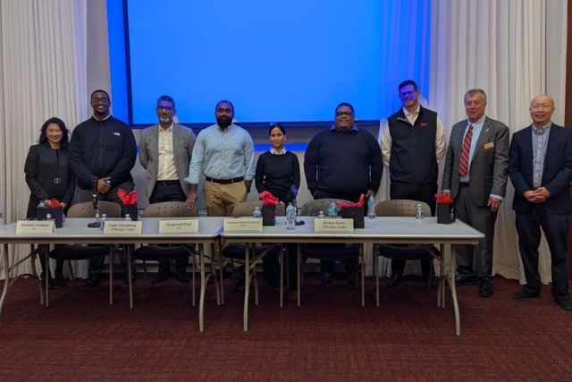 "Meet the Internal Auditors" panelists and attendees posing for a group photo in front of projector screen