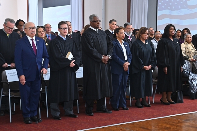Audience standing for prayer during the induction ceremony of Cassandra A. Johnson ’03C, ’06L