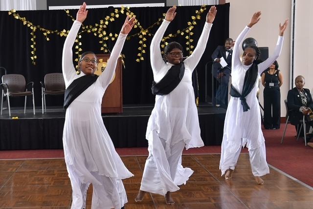 Girls dancing at MLK Dinner in special uniforms