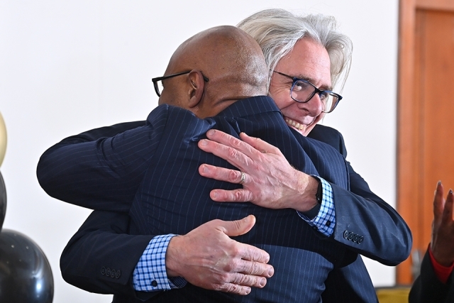 Simon Møller and man embracing in a hug