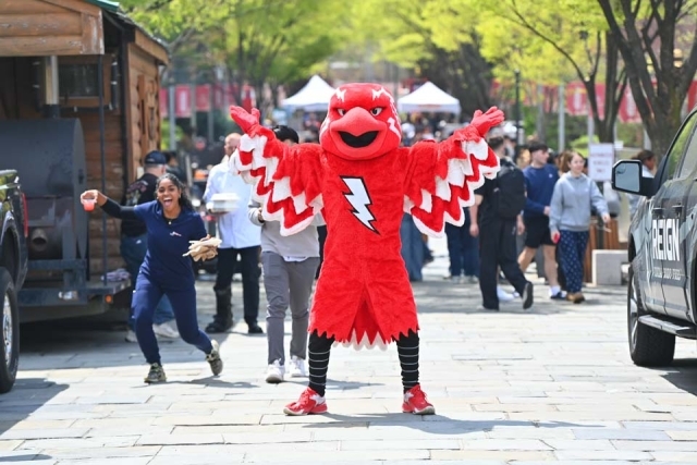 Johnny Thunderbird standing with his arms wide open at the Chartwells’ Blazing BBQ Brawl 