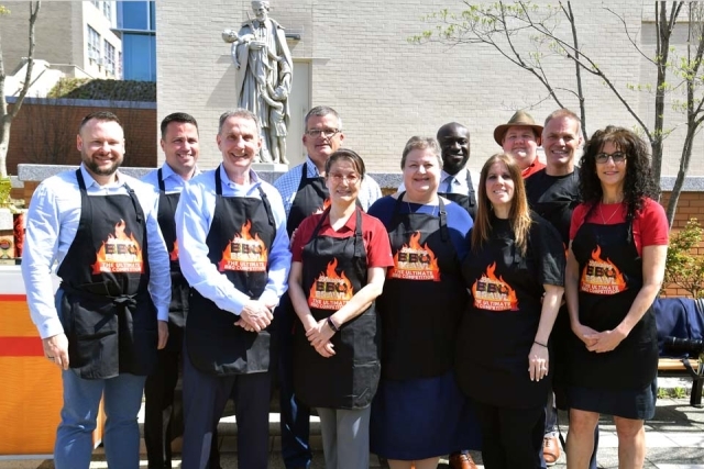 11 employees with Chartwells’ Blazing BBQ Brawl aprons 