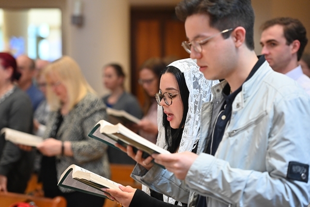 Students singing during Mass
