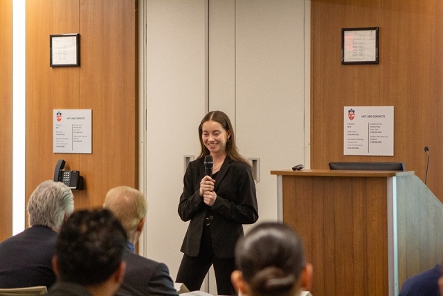 Female student presenting at James and Eileen Christmas Business Plan Competition