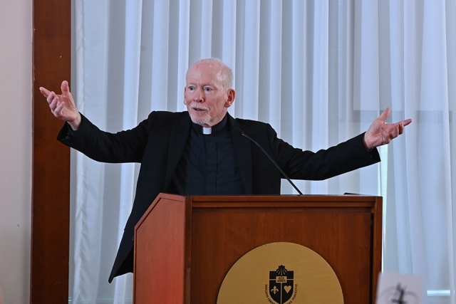 Father Shanley speaking at podium