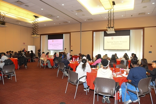 Students seated at tables for Spring Youth Writers Conference