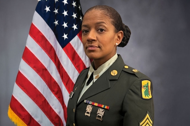 Sammantha O’Brien McCalla ’99CBA, ’01MBA, ’20Ph.D. headshot infront of American Flag