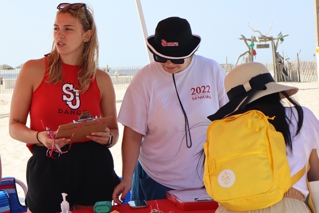 Signup tent for St. John's Alumni cleaning up the beach