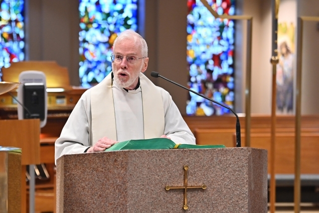 Rev. Michael J. Cummins, C.M. at podium in St. Thomas More Church