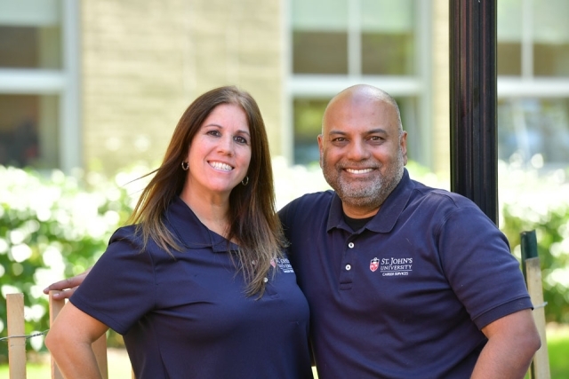 Male and female employee pose for photo