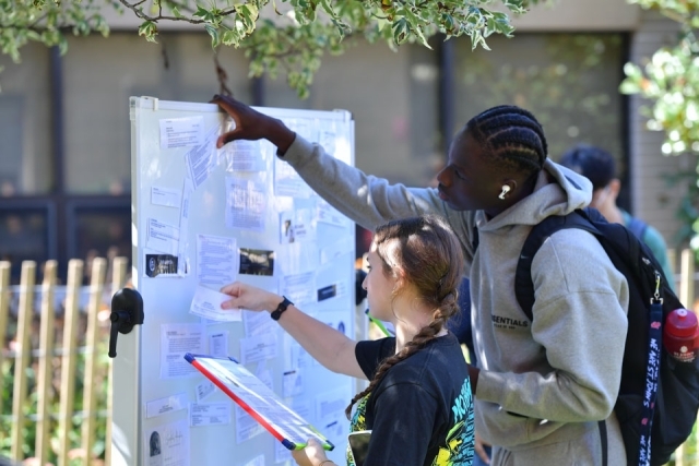 People looking at tri-fold poster