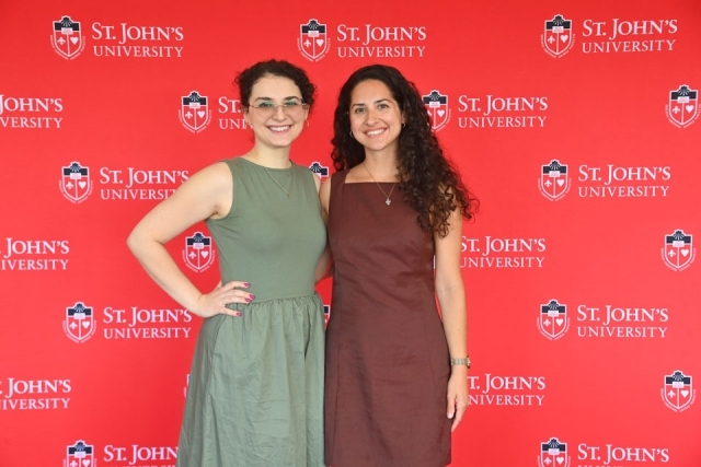 Two female faculty members standing