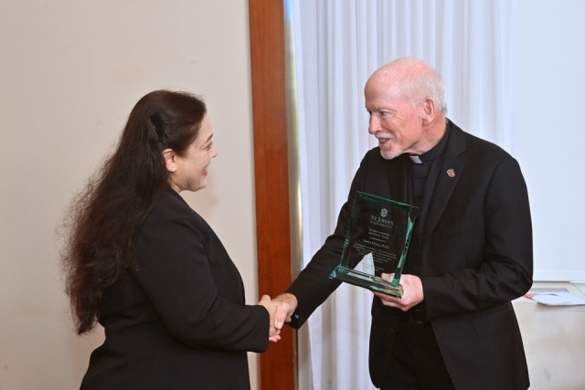 Fr. Shanley shaking hands with woman