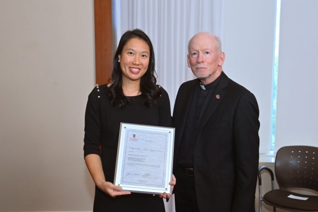 Fr. Shanley standing with female holding award