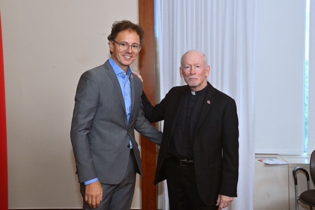 Fr. Shanley standing with male
