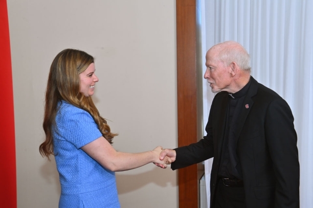 Fr. Shanley shaking hands with woman