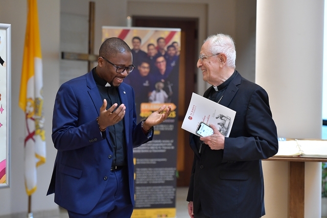 Priest in conversation with male