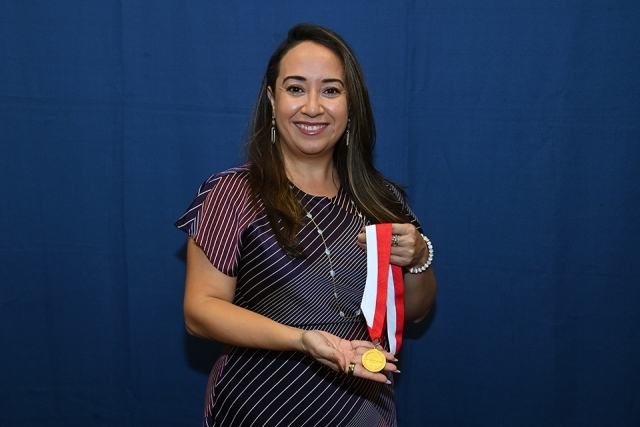 Female holding medal 