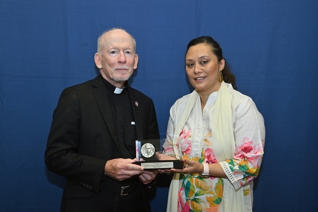 Fr. Shanley and female smiling for photo