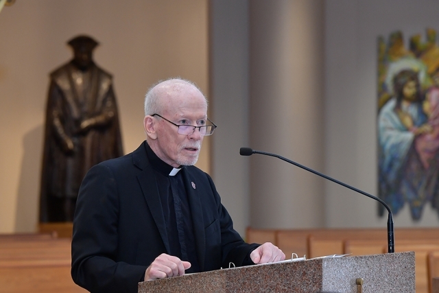 Fr. Shanley speaking at ambo