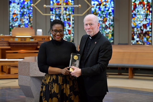 Female honoree and Fr. Shanley in church