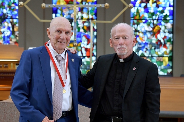Male honoree and Fr. Shanley in church