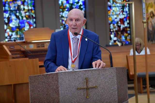 Male honoree speaking at ambo