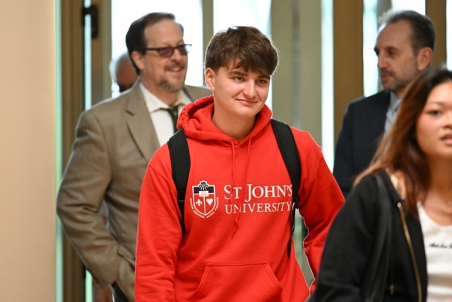 Student walking into St. Thomas More Church